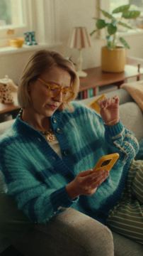 PensionBee ad — Woman delighted using app on her phone at home